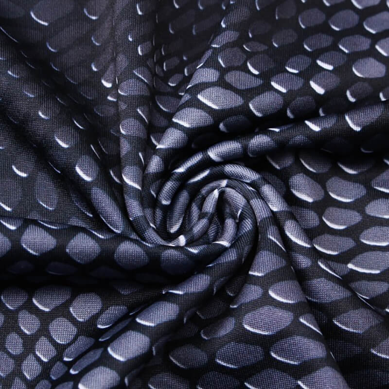 Close-up of snake skin 3D print on men's compression top, highlighting black and white pattern for stylish athletic wear.